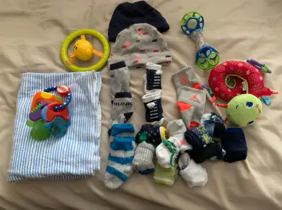 New Born Items 2 Hats, multiple socks, toys, one receiving blanket Smoke and pet free home pick up o...