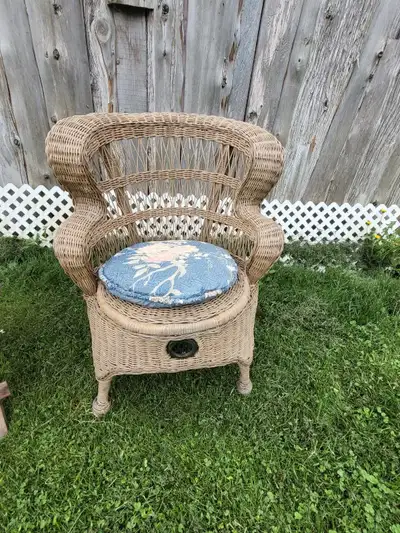 This is a charming wicker chair, perfect for adding a touch of vintage elegance to your sunroom or p...