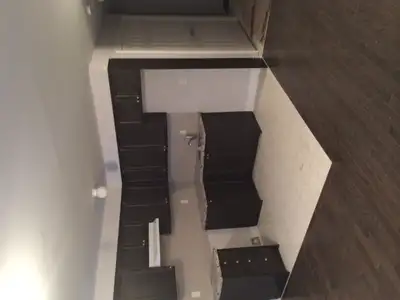 This Midtown bachelor apartment boasts beautiful espresso, shaker cabinets in the kitchen with quart...