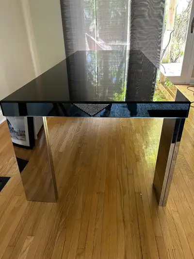 contemporary black  glass table. Legs are silver mirror., View more