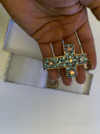 small lady's cross with gems in case 