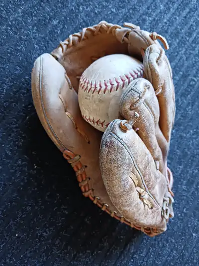Baseball glove with softball, View more