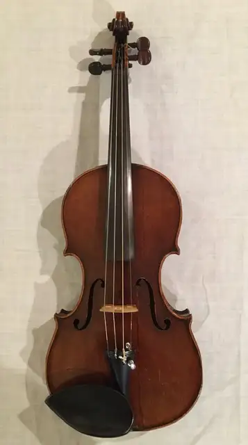 Violin, made in Saxony, Germany between 1900 and 1920. It has the old style neck and dark coloured s...