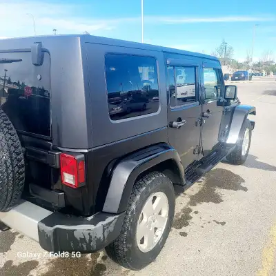 This 2009 Jeep Wrangler Sahara is a capable and rugged off-road machine finished in a sleek black ex...