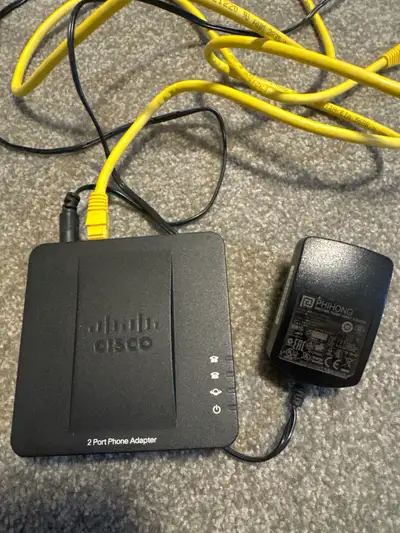 This Cisco SPA112 2-Port Phone Adapter is in good working condition and ready to provide reliable Vo...
