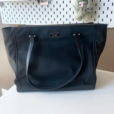 Authentic Kate Spade New York black tote. Spacious and practical – perfect for work, school, or ever...