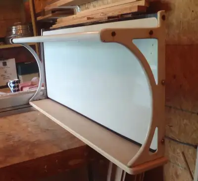 This antique stove back has been converted to a wall hanging shelf. The porcelain back is magnetic....