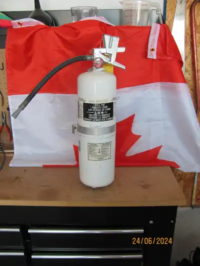 FIRE EXTINGUISHER – 5” Diameter 20”H Weighs 15 lb. Rechargeable.