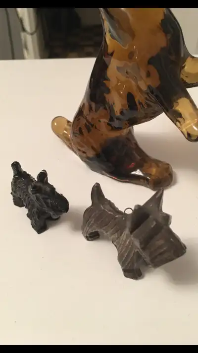 THREE SCORTIE DOGS ORNAMENTS LARGE BLOWN GLASS STANDING SNALL SOLID IRON AND SMALL METAL BROWNISH DO...