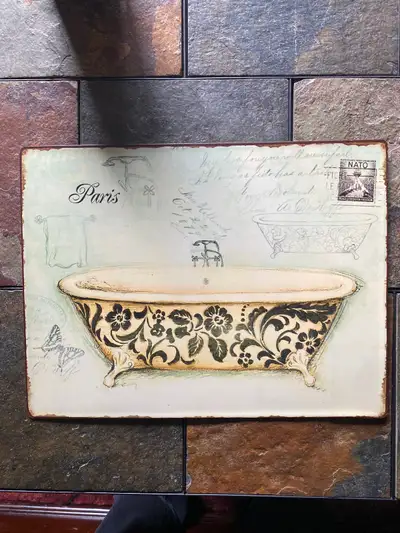 Very interesting metal wall art for bathroom with clawfoot bathtub as primary image in foreground wi...