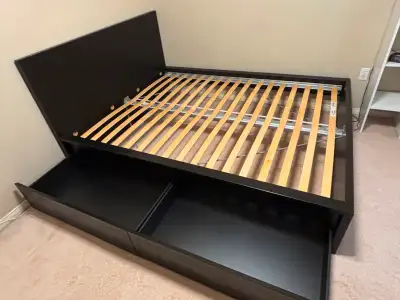 Black wooden bed frame, queen sized. Includes the two drawers that go underneath. 83 inches in lengt...
