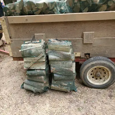 Large mesh bags of dry Firewood for sale. 2.5 cubic ft. ( Approx 60 lbs ). Some kindling included in...