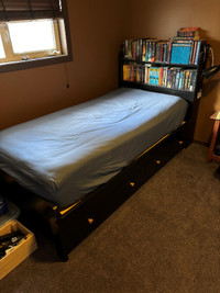 Twin bed with mattress.