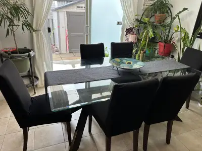 Glass dining table with 6 chairs plus covers for chairs glass table has a small chip a the end scrat...