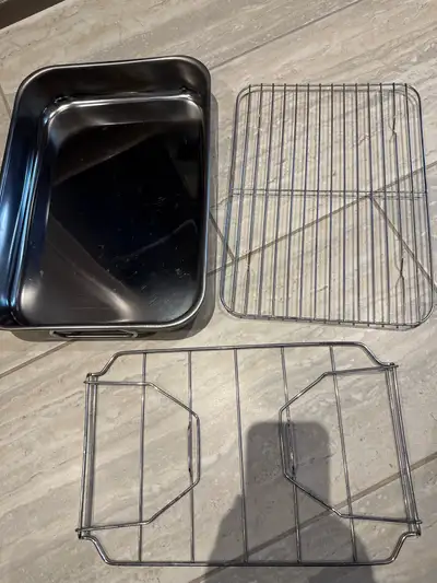 1) 11” x 15” stainless steel pan with flat insert and carry insert. The pan also has handles. In gre...