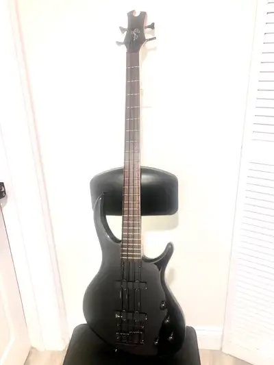 This Epiphone Tobias Bass guitar is a sleek, all-black instrument perfect for any bassist looking fo...