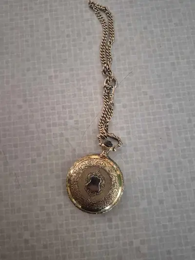 Selling Girl a pocket watch. Don't think it works. Not real gold. Good collector item.