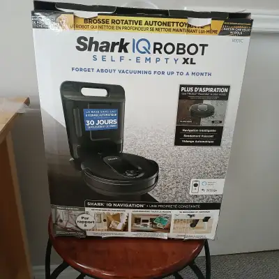 Shark IQ Robot vacuum with self - empty canister. Used a few times but in box with all components in...