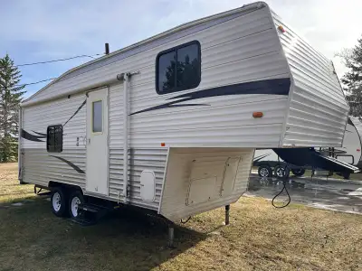 This fifth wheel has some hail damage on the tin, front master bedroom, large living area with fold...