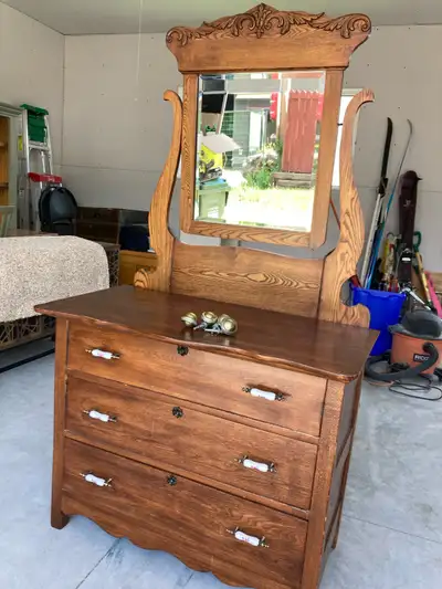 Antique dresser with mirror. Original wheels. $50 obo.