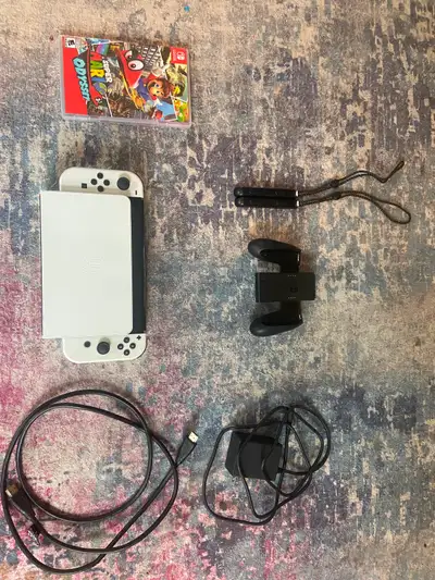 White OLED Nintendo switch with Super Mario Odyssey, View more