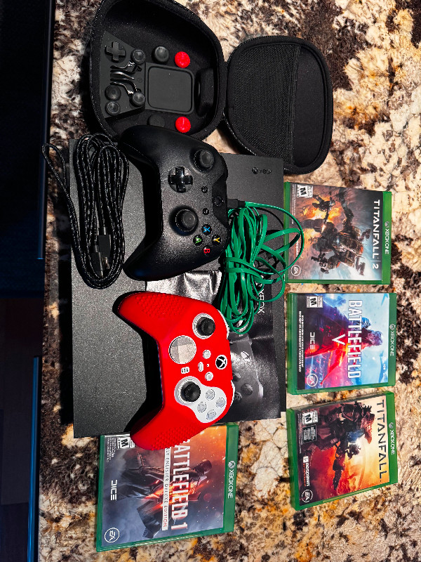 X Box One X with 2 controllers and 4 games in XBOX One in Ottawa
