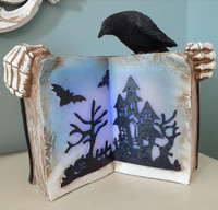 Creepy light up Halloween book with raven and skeleton hands