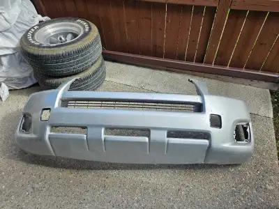 2010 toyota rav4 front bumper cover with a light crack on the edge of the bumper.. silver in color