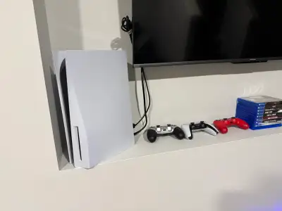 PS5 (with box) with 9 games and 3 controllers, View more