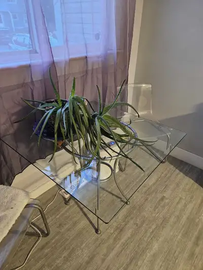 Silver table legs with glass table top. 38 inches wide, View more