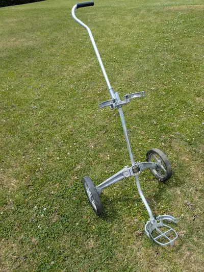 Aluminum golf trolley. Newer velcro straps included. Nice piece of vintage equipment. Tires likely n...