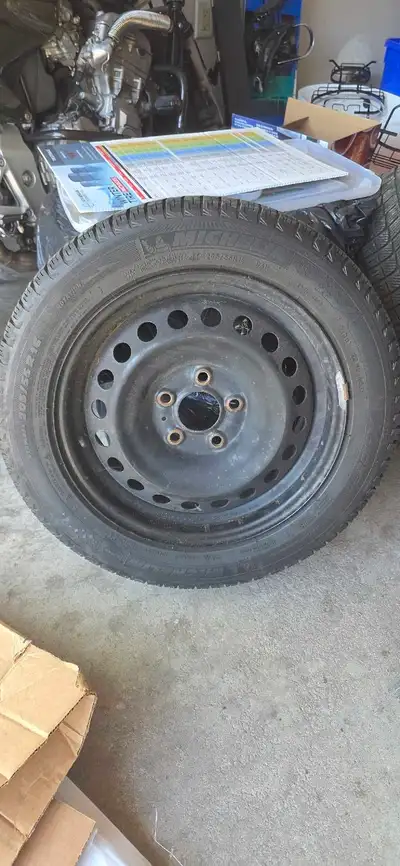 These Michelin 205/55 R16 winter tires come mounted on black steel rims and are ready to help you ta...