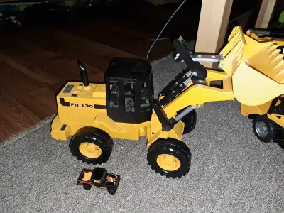 Toy truck front end loader Hot wheels car for size reference Wheels are rubber Pivots like the real...