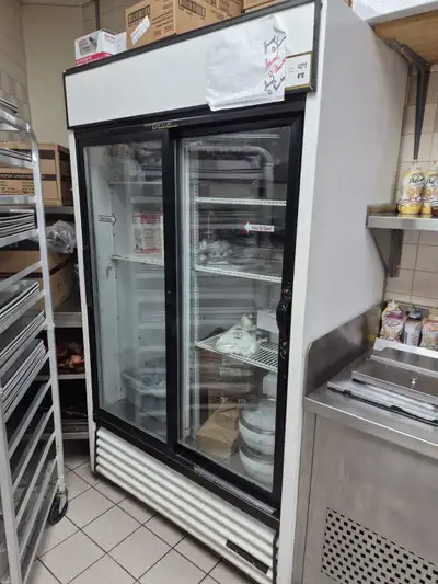 Spacious TRUE brand commercial refrigerator with two glass sliding doors. Keeps everything nice and...