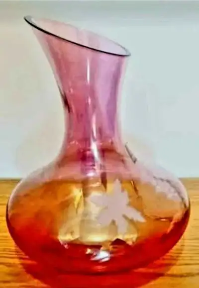 This unique, Iridescent Cranberry-coloured Roscher Decanter features a Hand-crafted etched vine patt...