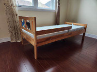 Junior bed with guard and mattress, made of natural solid wood
