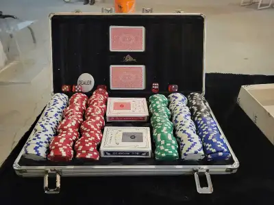For sale is a new poker set, complete with chips, cards, dice, and a dealer button, all neatly organ...