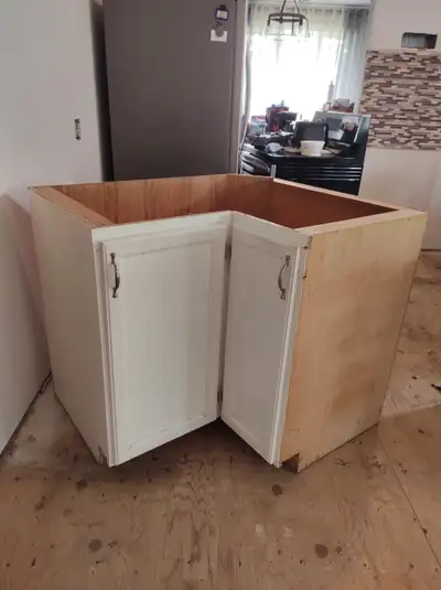 2 corner cabinet for sale one has 4 drawers in it plus 1 center cabinet. Counter top with a double s...