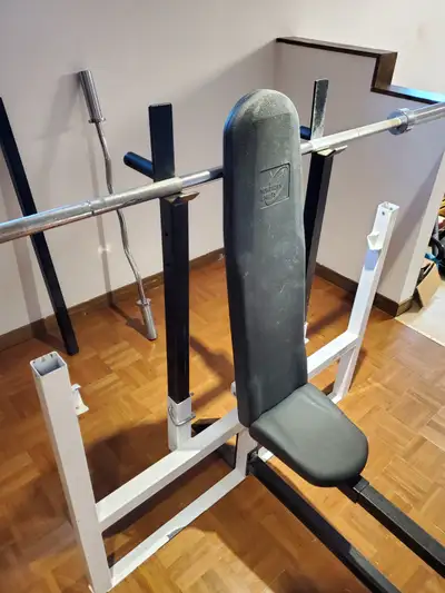 Weight bench with weights, curl bar, and weight rack., View more