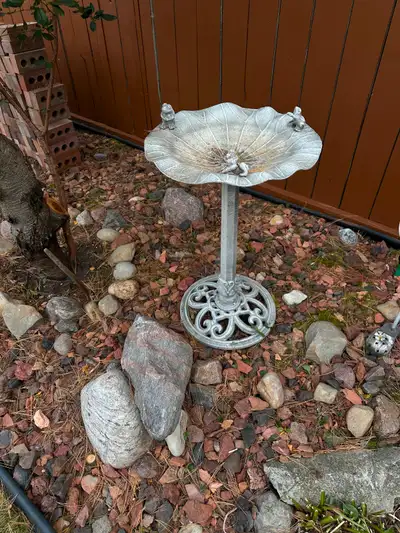 Silver colour metal birdbath.