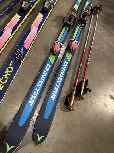 Two pairs of retro down hill skis. Dynastar 150s with original tyrolia 160 bindings, and look ski po...