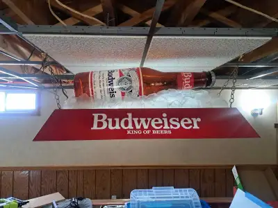 Light up your space with this iconic Budweiser beer light, featuring a bottle and the classic "King...