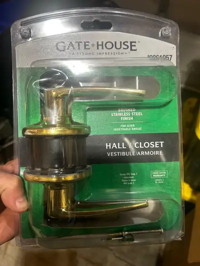 Used closet gold lever with a brushed stainless steel finish, still sealed in its original packaging...