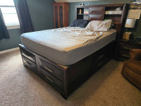 Queen wood bed frame with storage and charge ports.