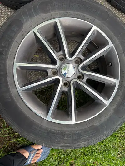 Selling a set of four used Dodge rims with tires, each boasting a 225/65R17 specification. These rim...