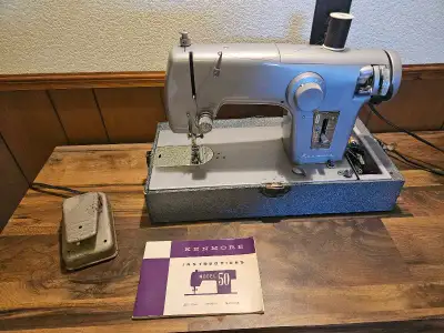 This is a vintage Sears Kenmore sewing machine, a portable zig-zag model ready to tackle your sewing...