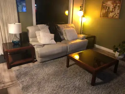 This set includes a coffee table and two matching end tables, all crafted from solid wood with a ric...