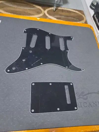 Selling a stratocaster pickgaurd and back plate.