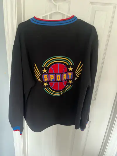This Miracle Sport Crewneck is a stylish addition to any wardrobe, featuring a unique basketball des...