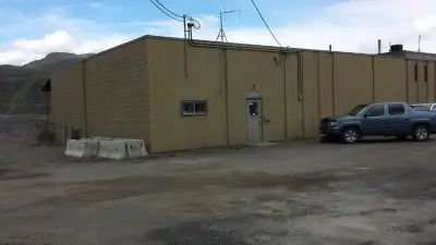 Warehouse with loading dock and office for rent. Large compound yard. Lease length negotiable.